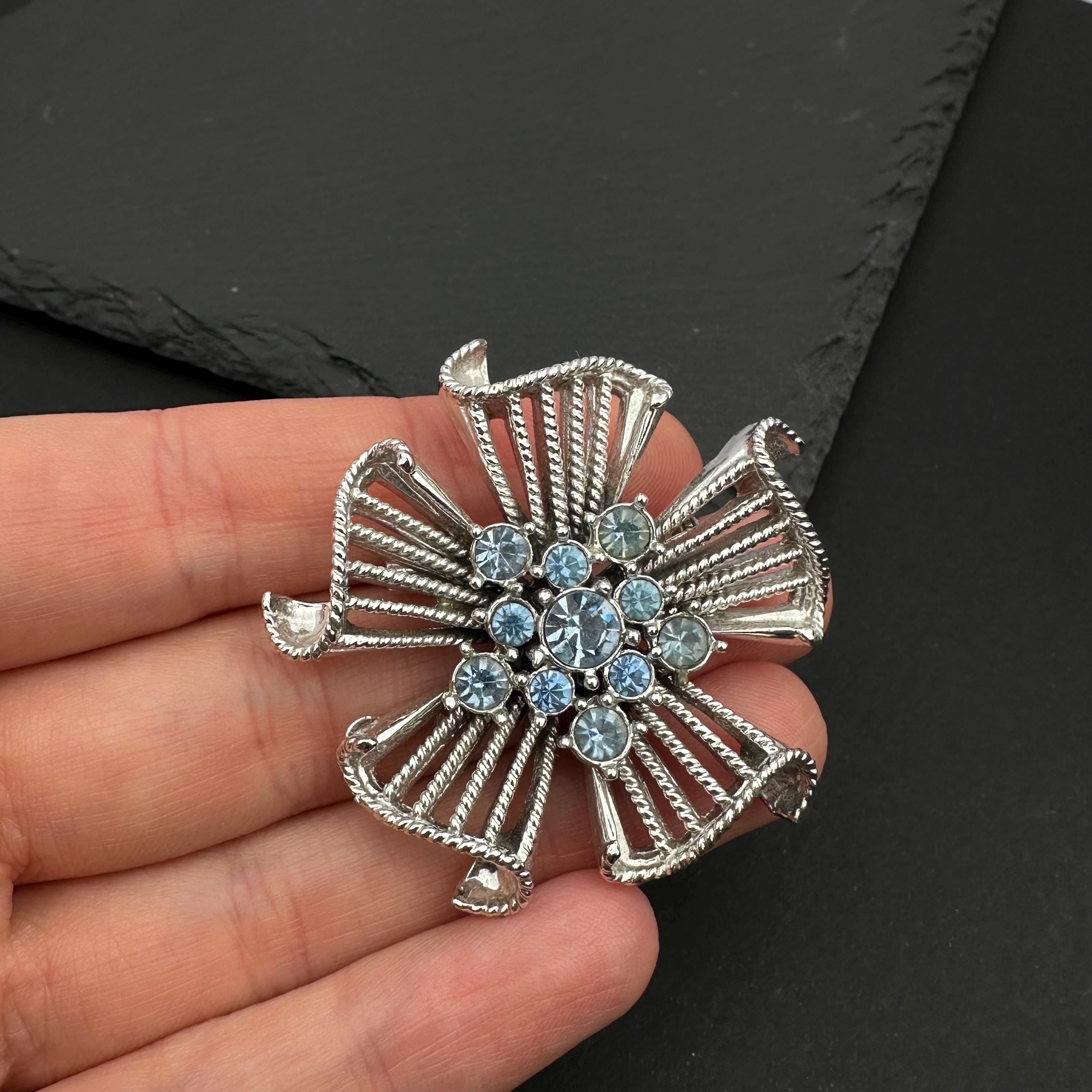 Vintage silver tone and blue rhinestone flower brooch