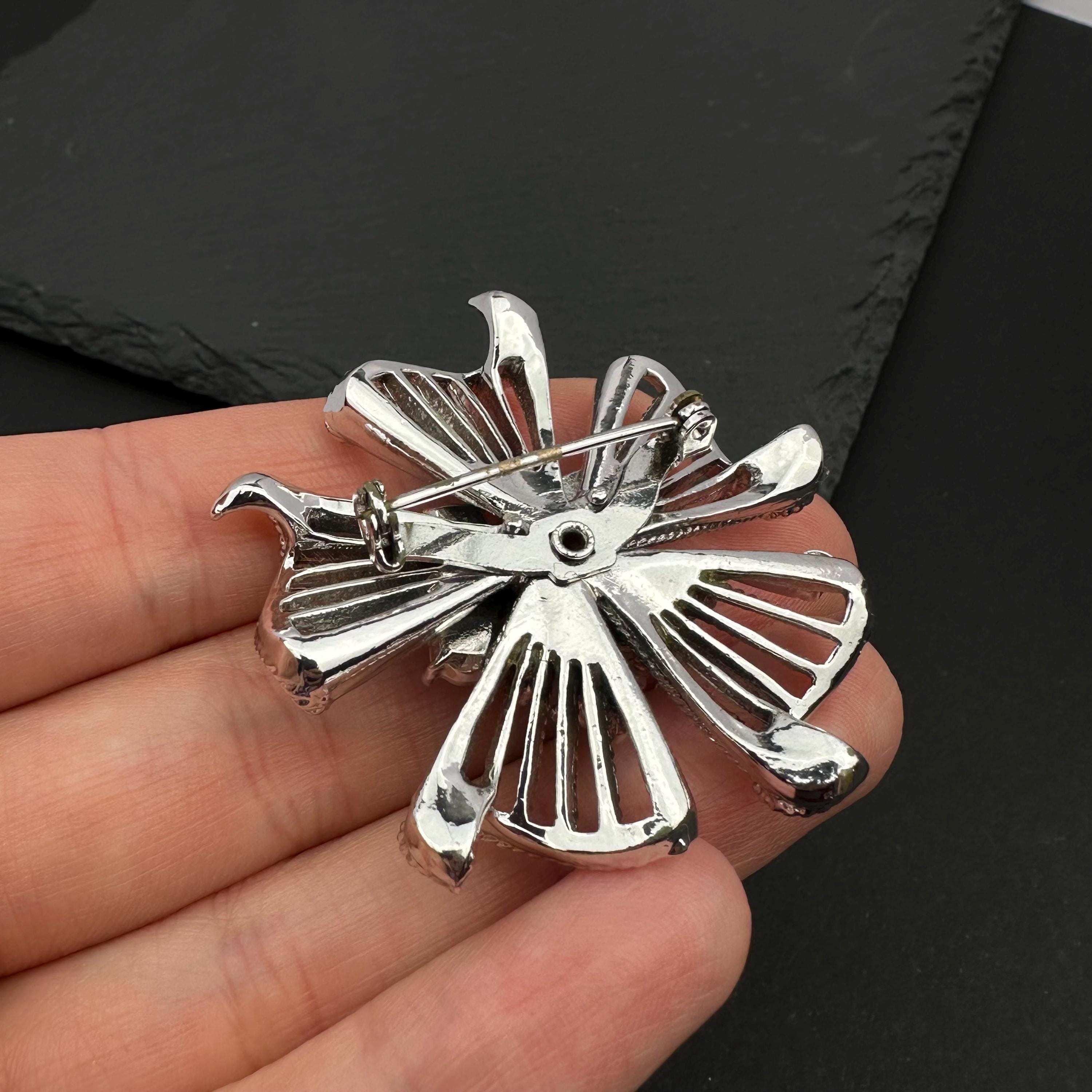 Vintage silver tone and blue rhinestone flower brooch
