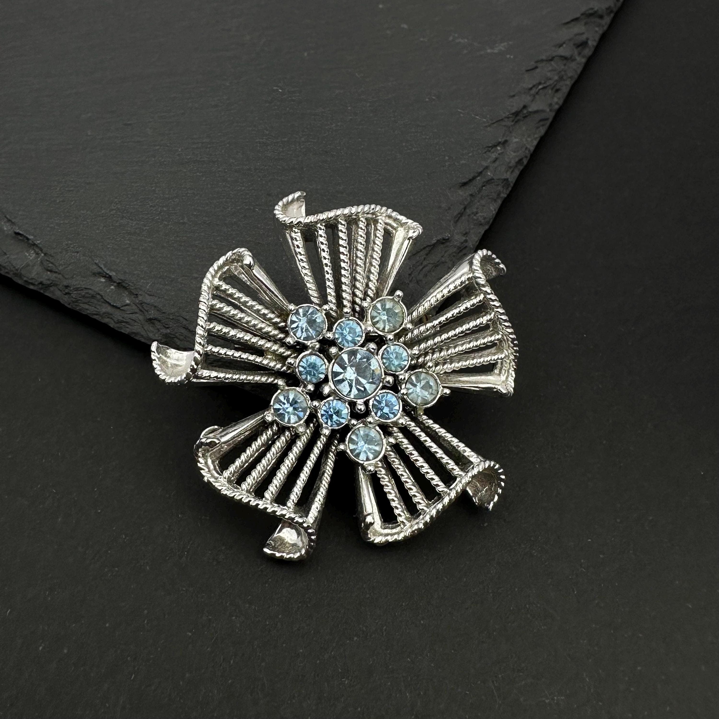 Vintage silver tone and blue rhinestone flower brooch