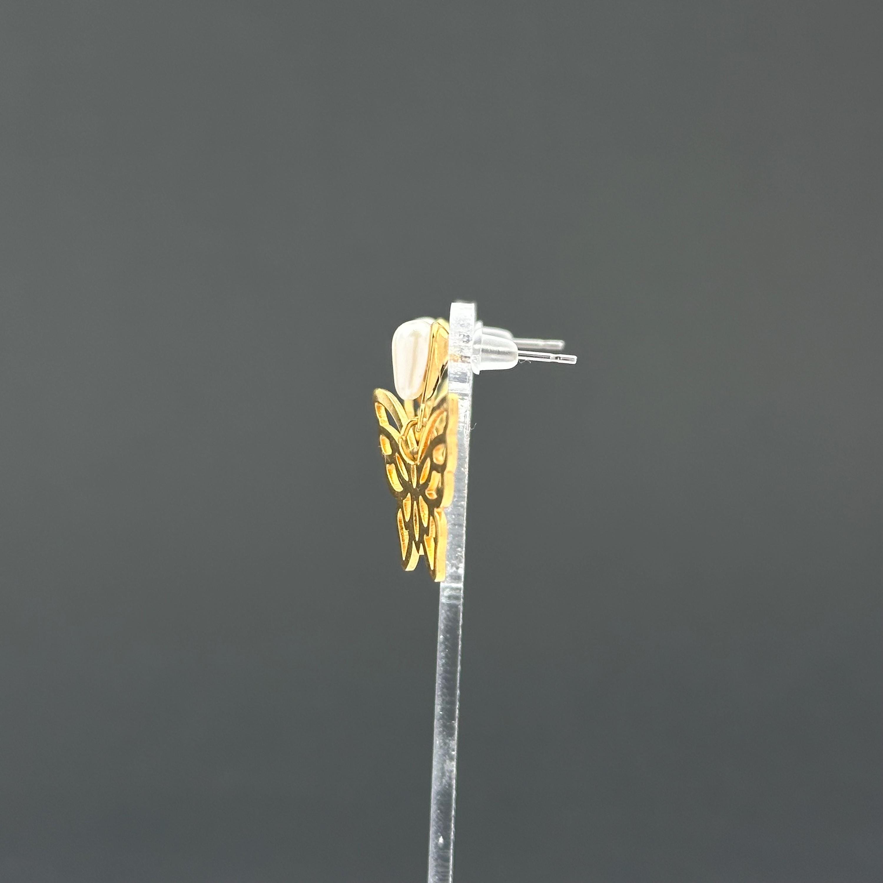 Vintage gold-tone butterfly earrings with faux pearl