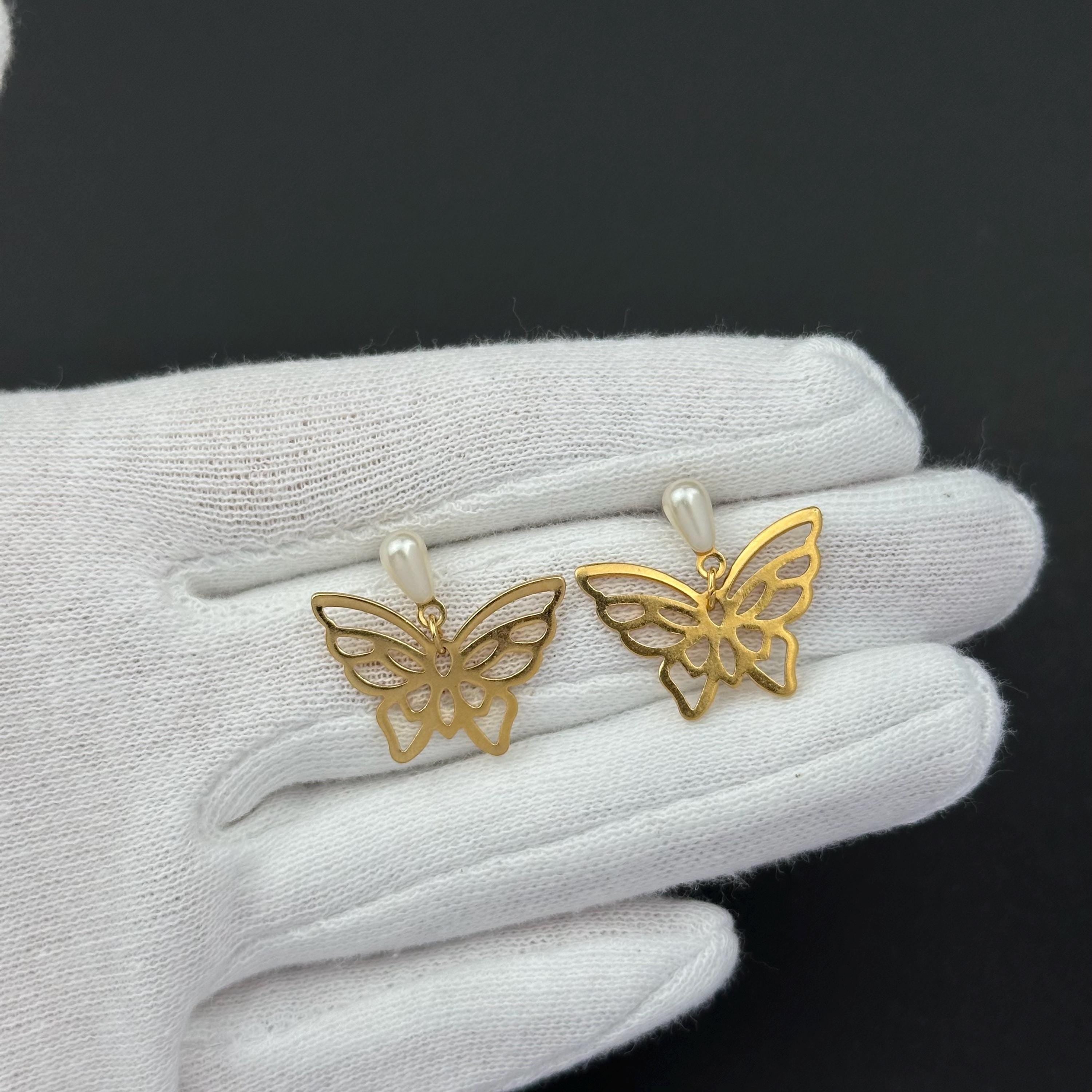 Vintage gold-tone butterfly earrings with faux pearl
