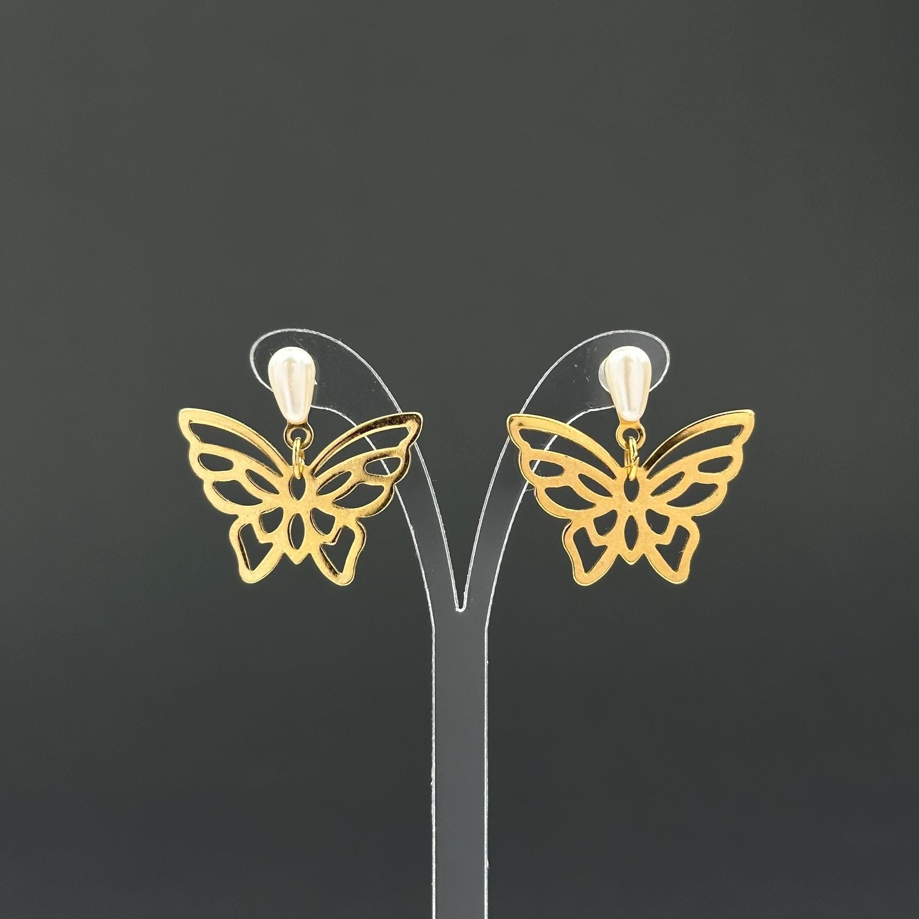 Vintage gold-tone butterfly earrings with faux pearl