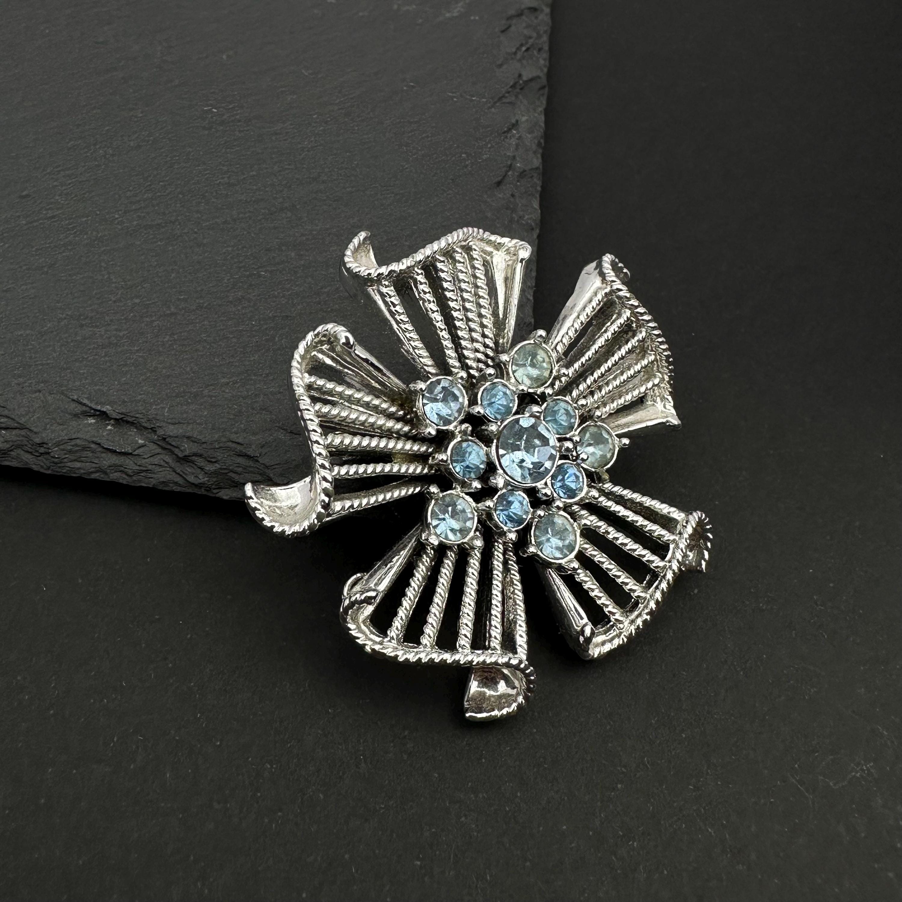 Vintage silver tone and blue rhinestone flower brooch
