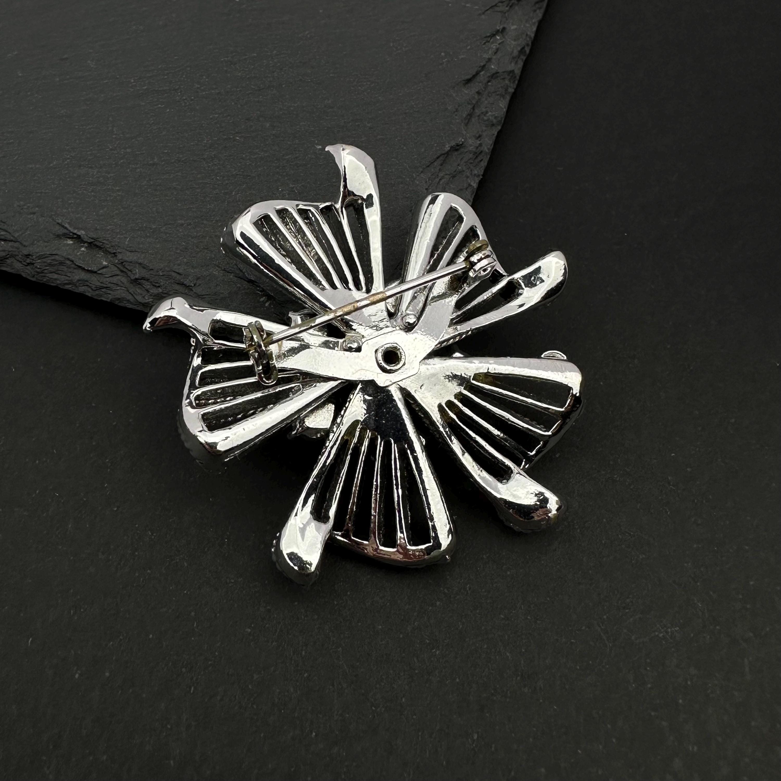 Vintage silver tone and blue rhinestone flower brooch