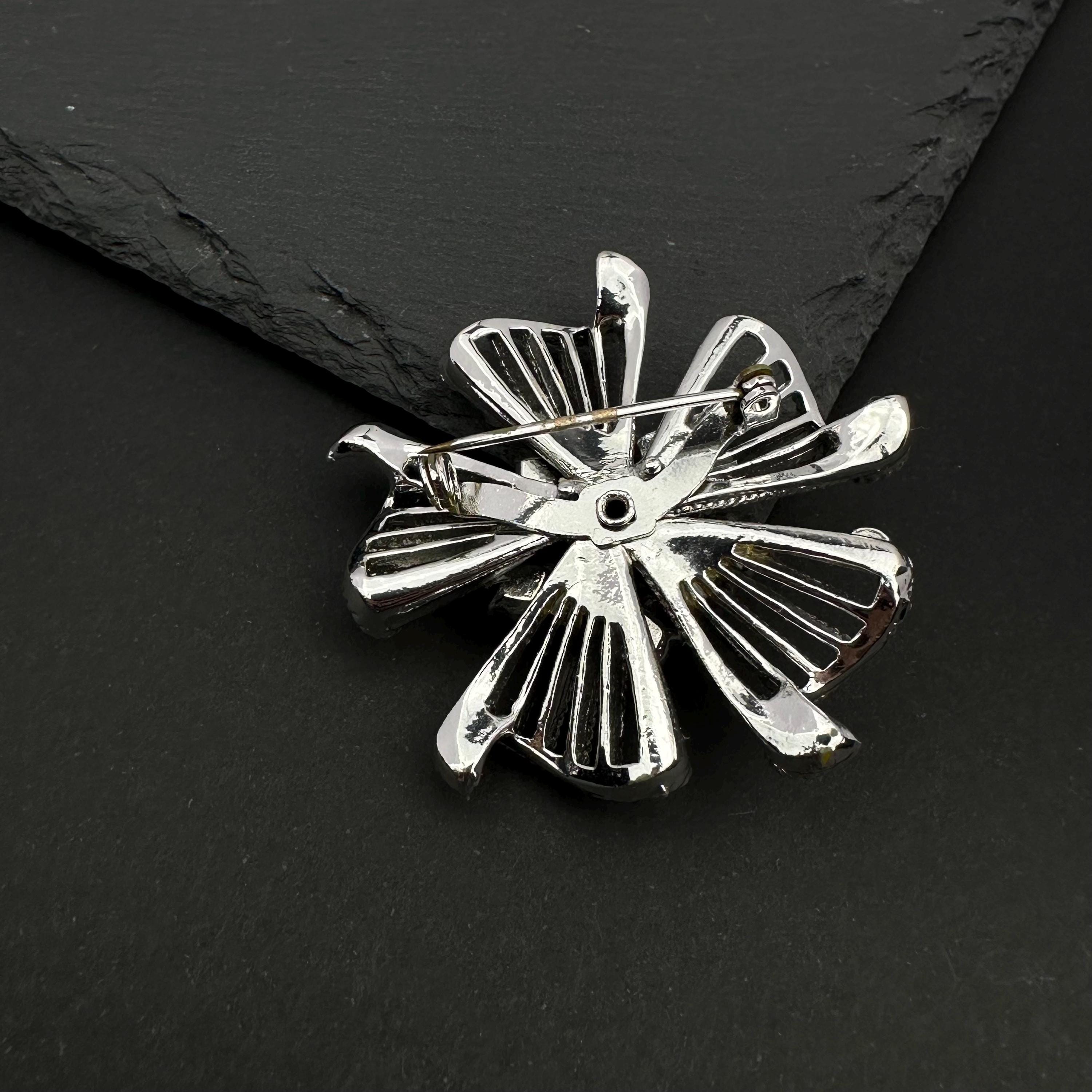 Vintage silver tone and blue rhinestone flower brooch