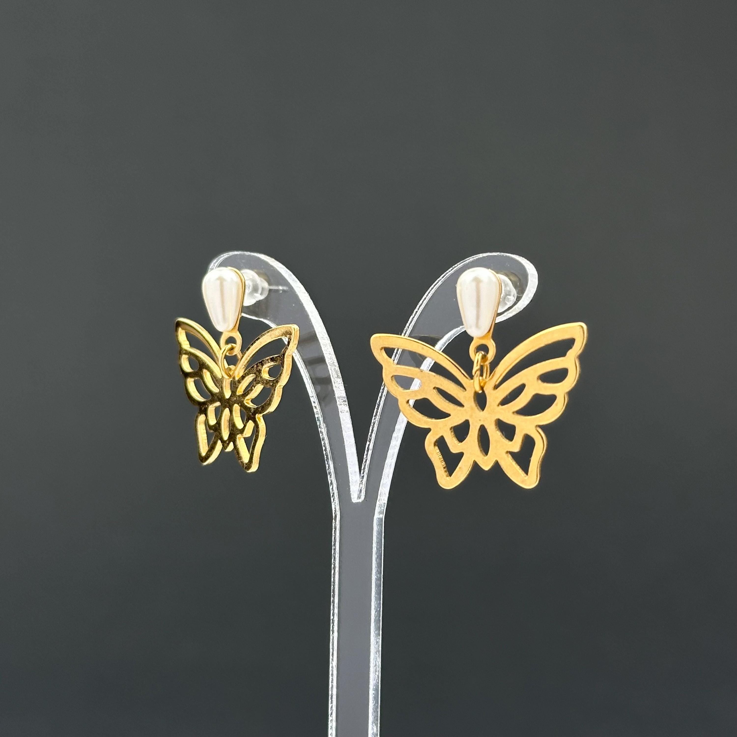 Vintage gold-tone butterfly earrings with faux pearl