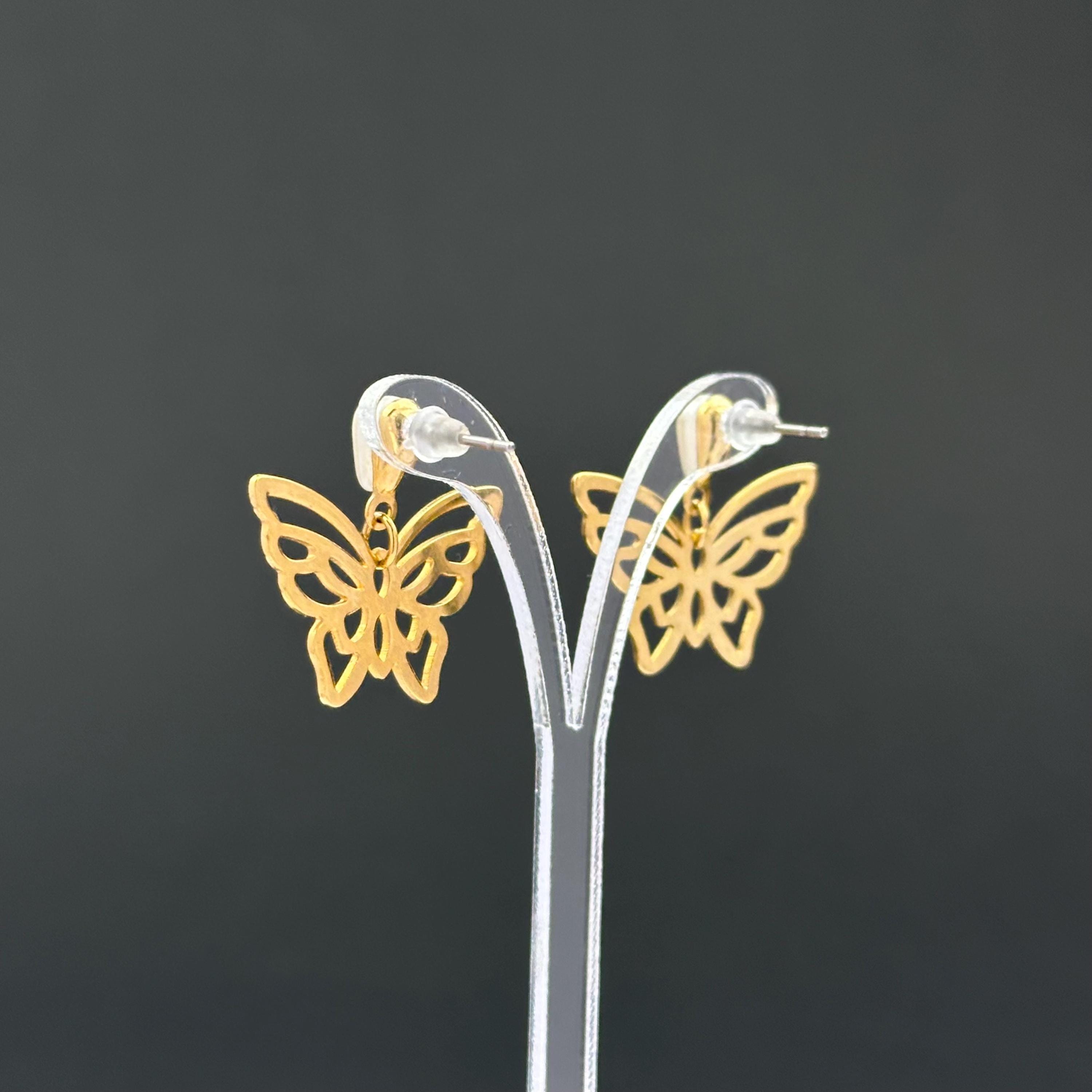 Vintage gold-tone butterfly earrings with faux pearl