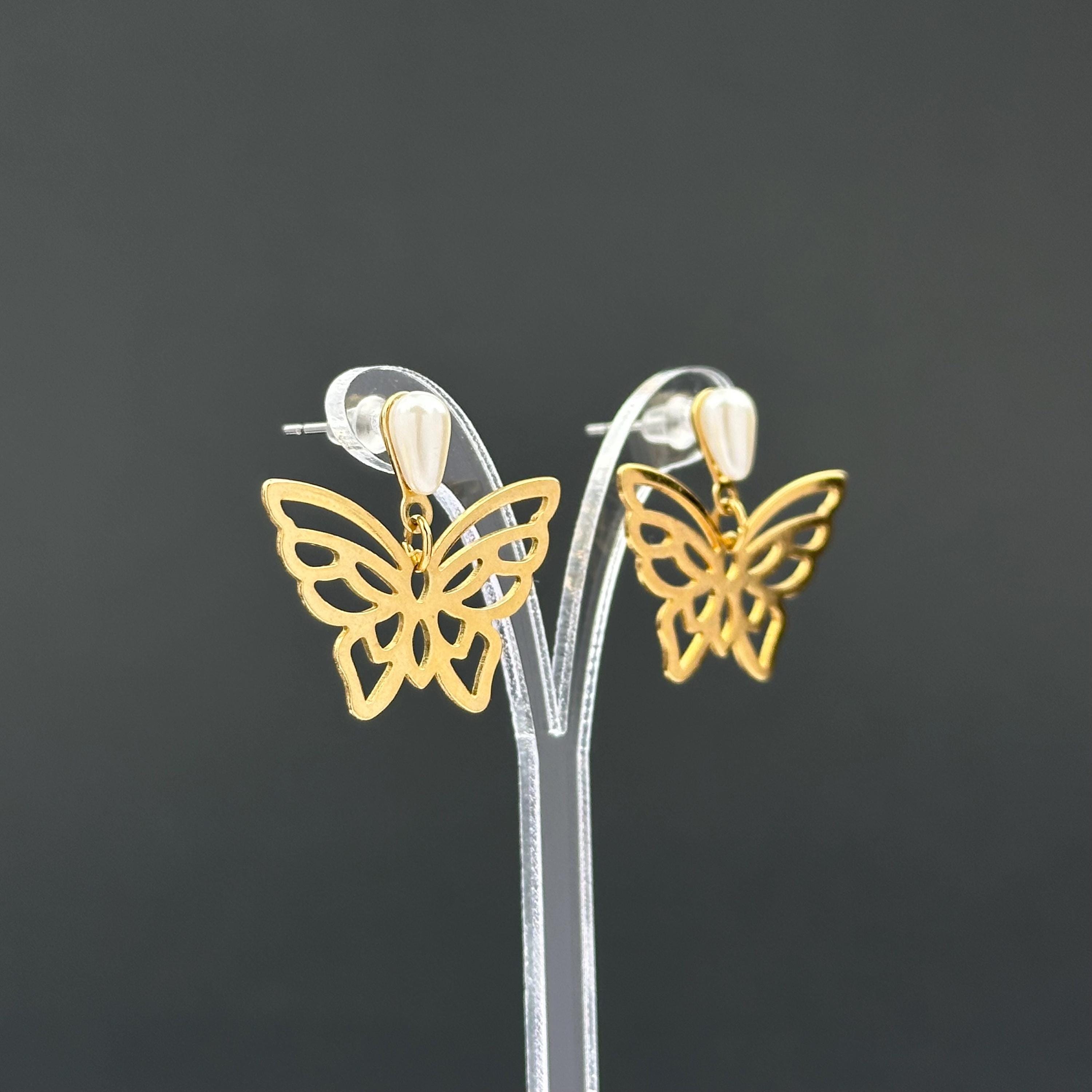 Vintage gold-tone butterfly earrings with faux pearl