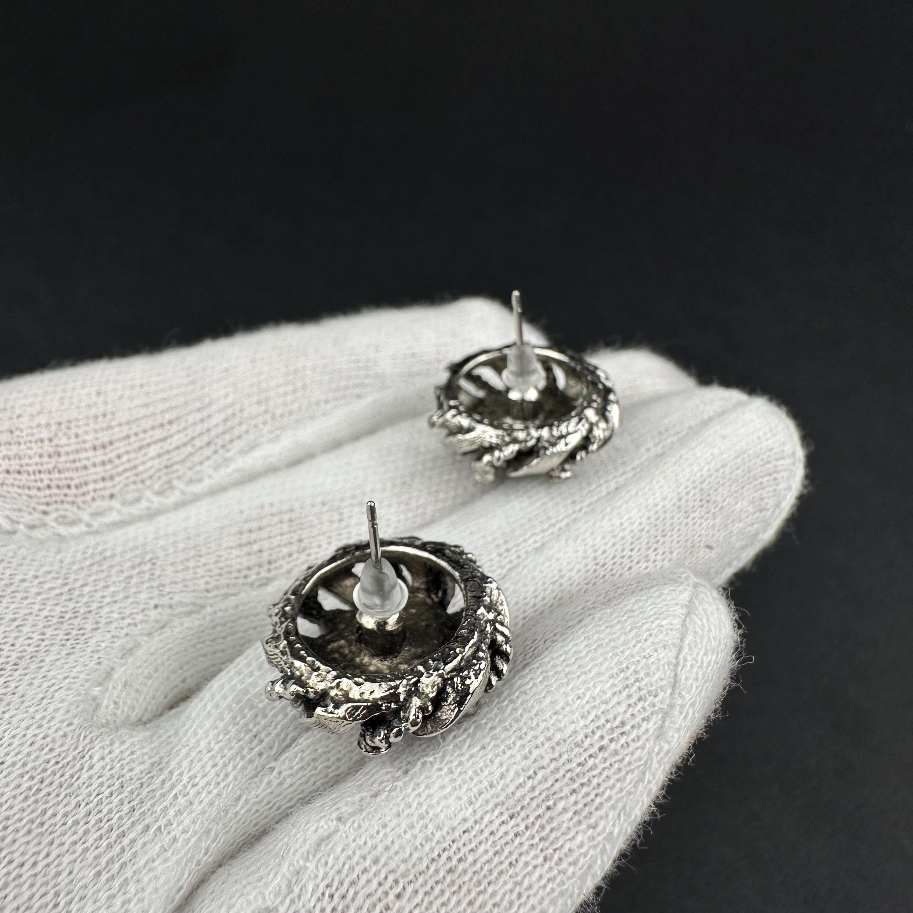Vintage silver-tone round earrings with black plastic center