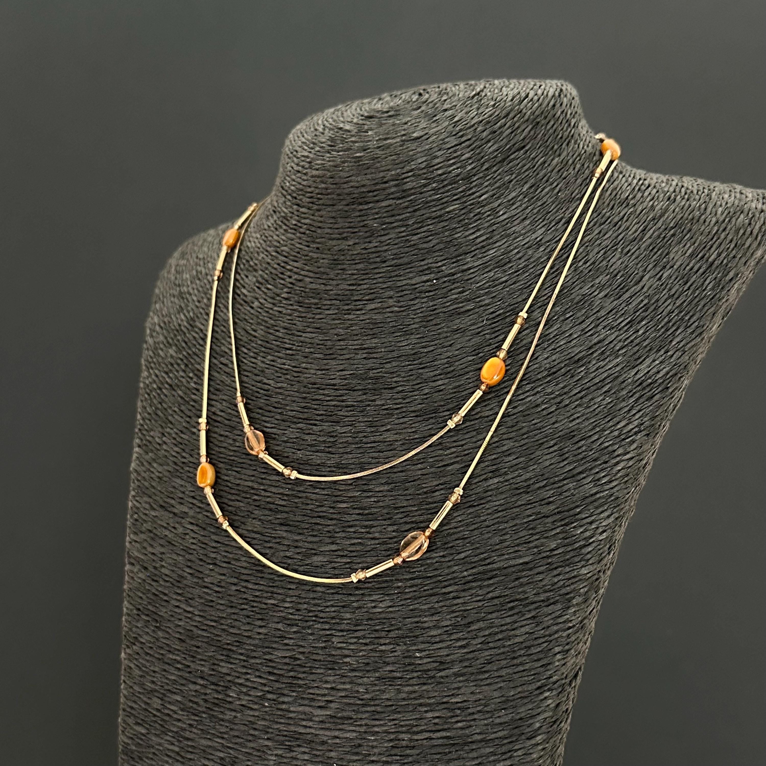 Vintage long gold-tone and amber plastic beads necklace
