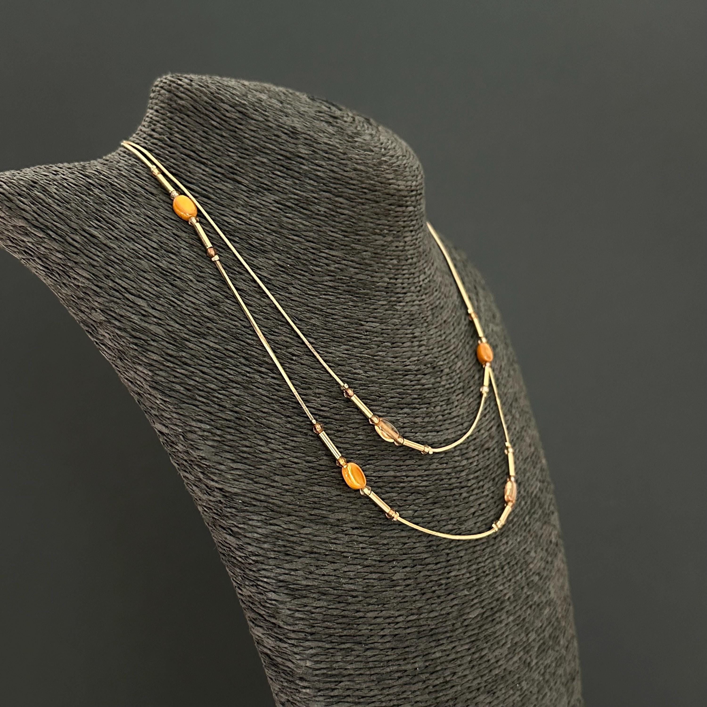 Vintage long gold-tone and amber plastic beads necklace