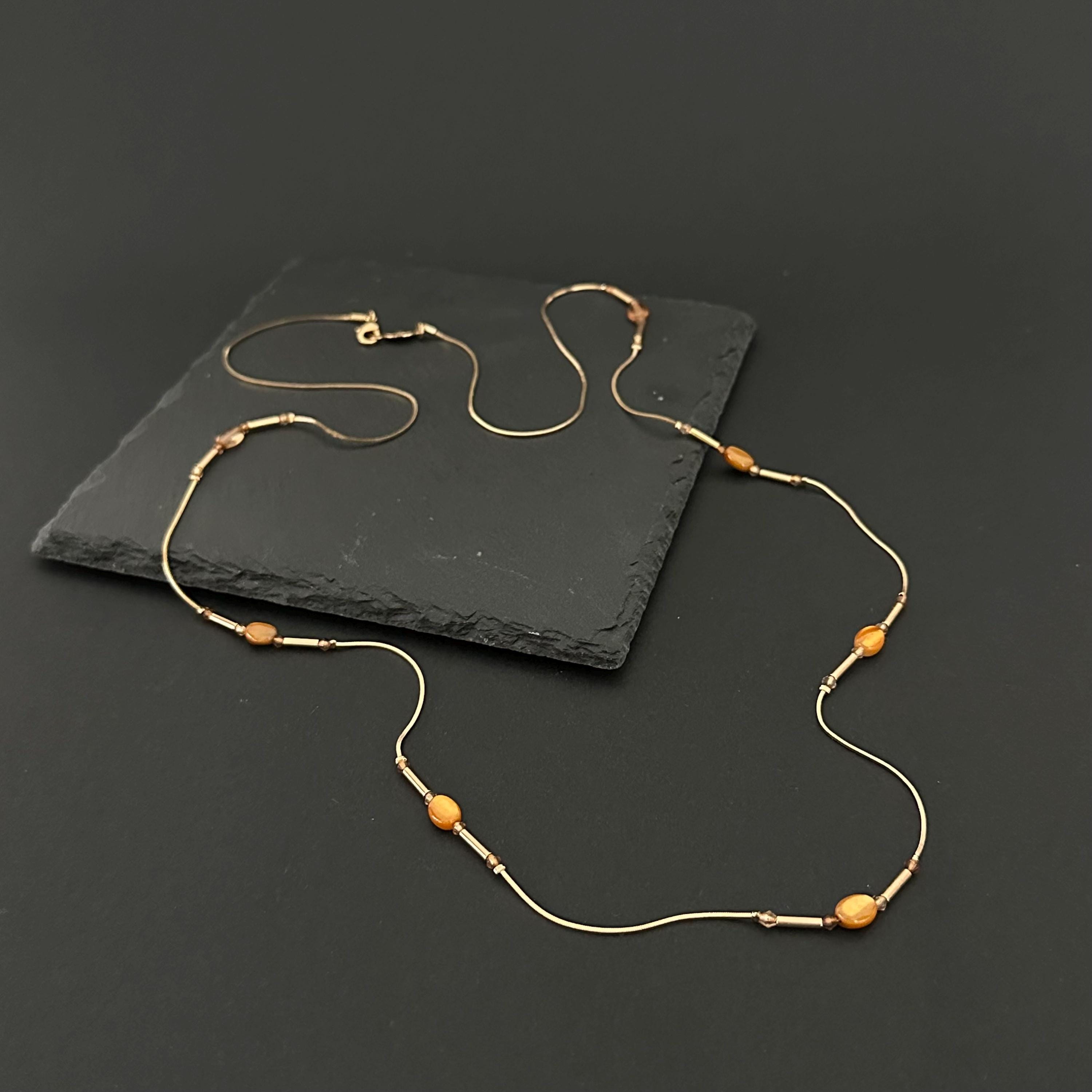 Vintage long gold-tone and amber plastic beads necklace