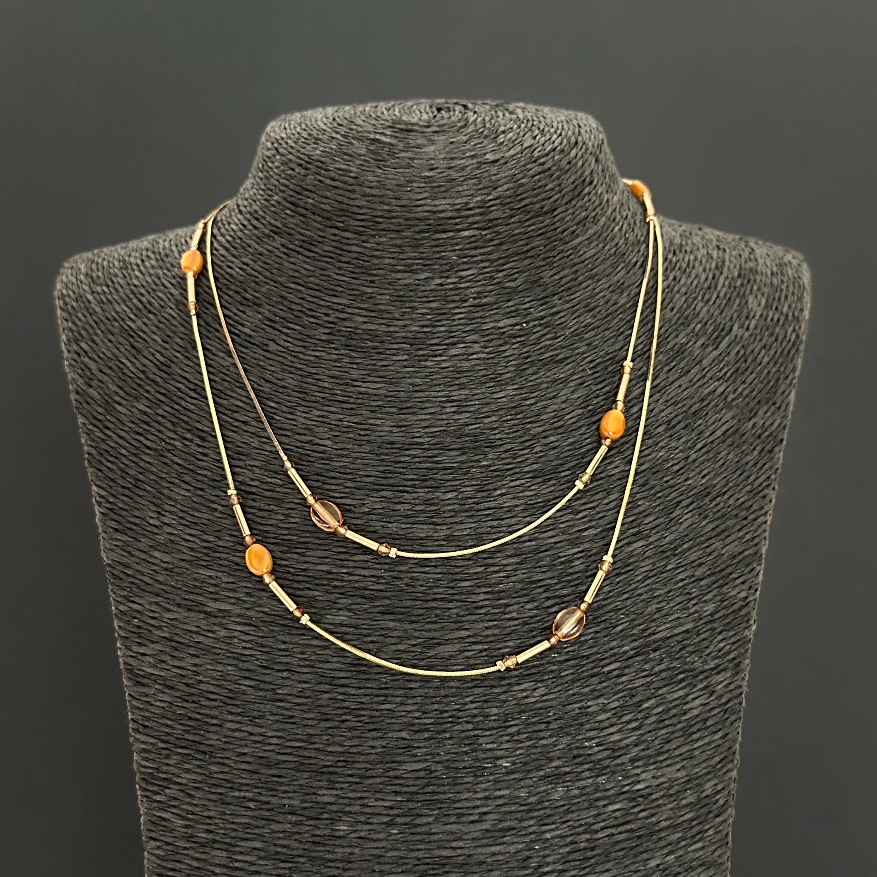 Vintage long gold-tone and amber plastic beads necklace