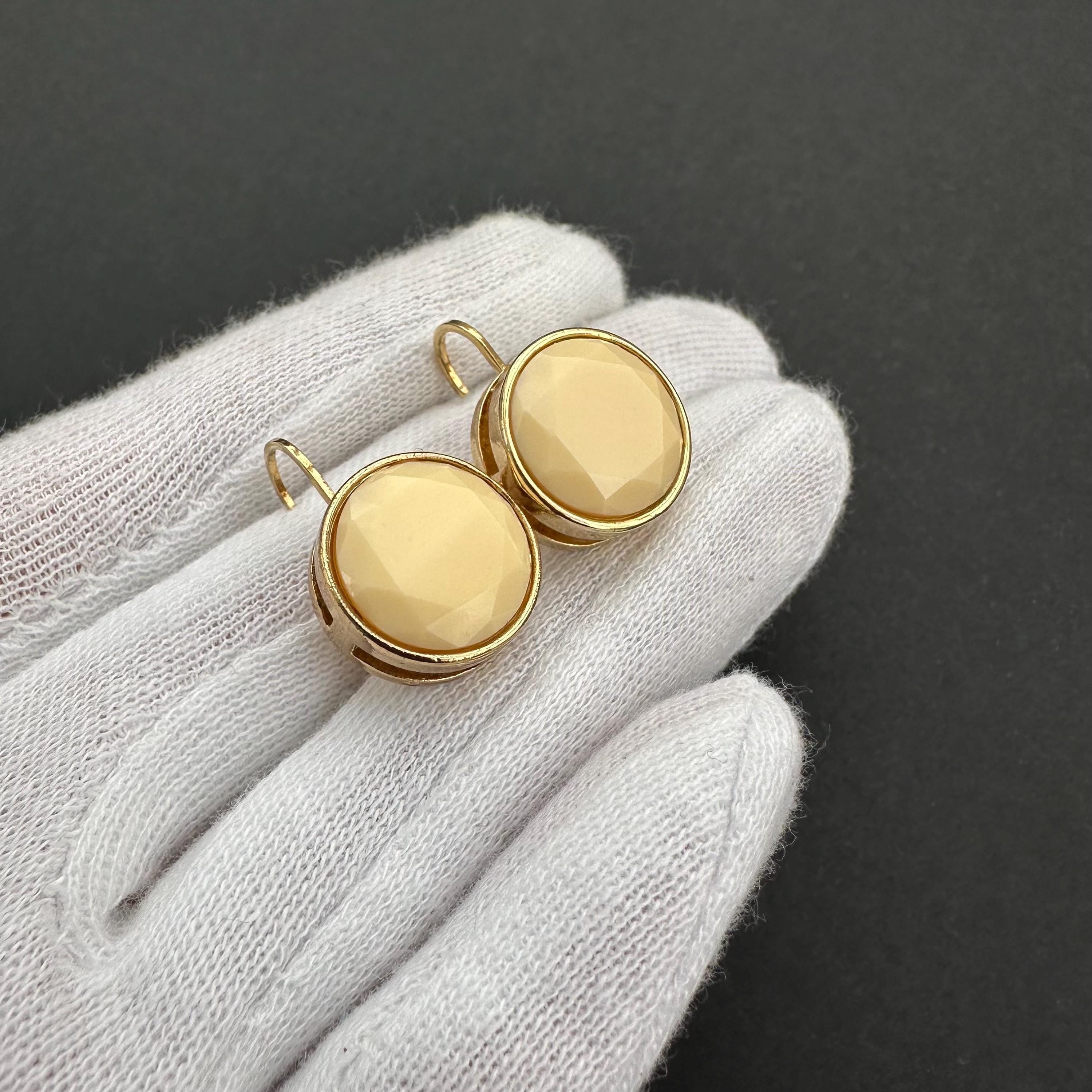 Vintage gold-tone and beige cabochons dangle openwork earrings