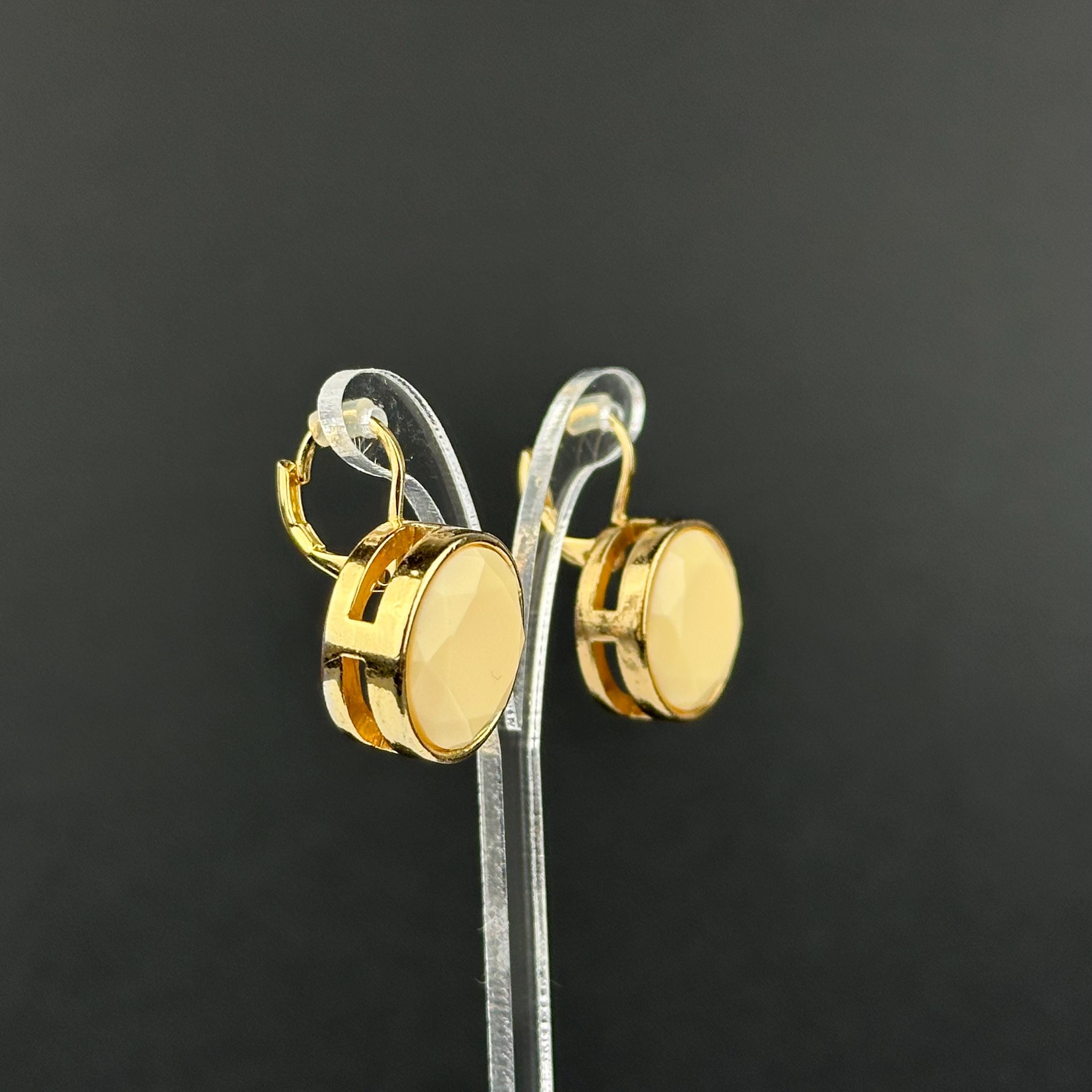 Vintage gold-tone and beige cabochons dangle openwork earrings