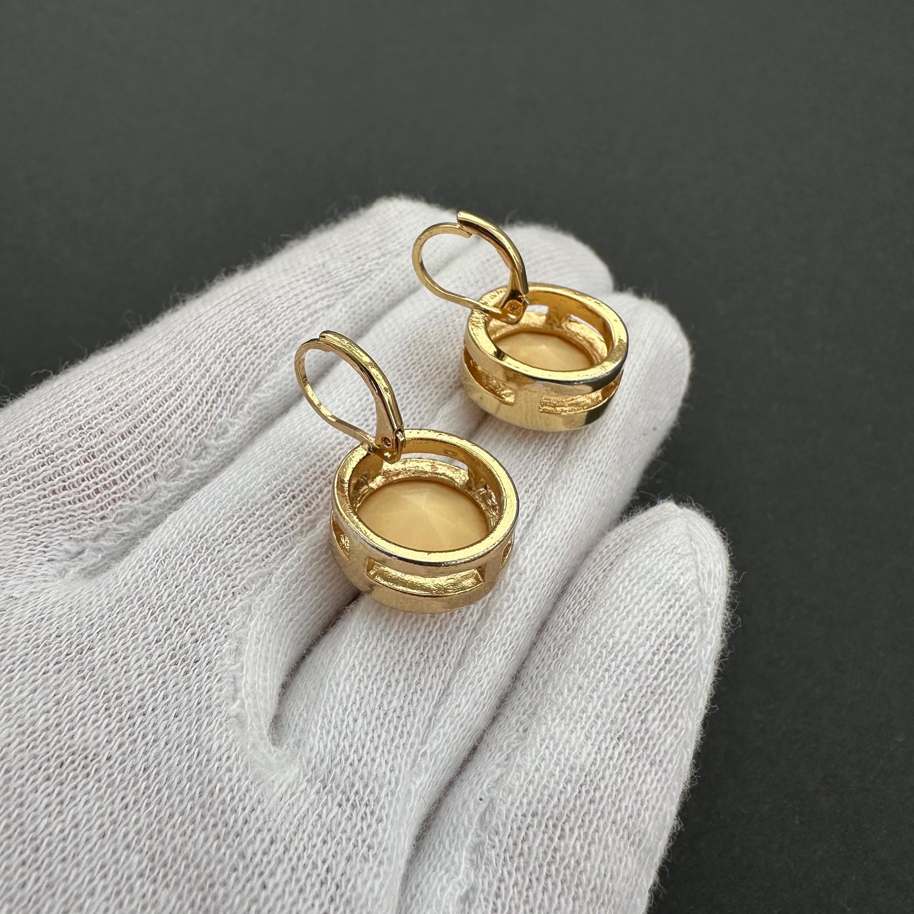 Vintage gold-tone and beige cabochons dangle openwork earrings