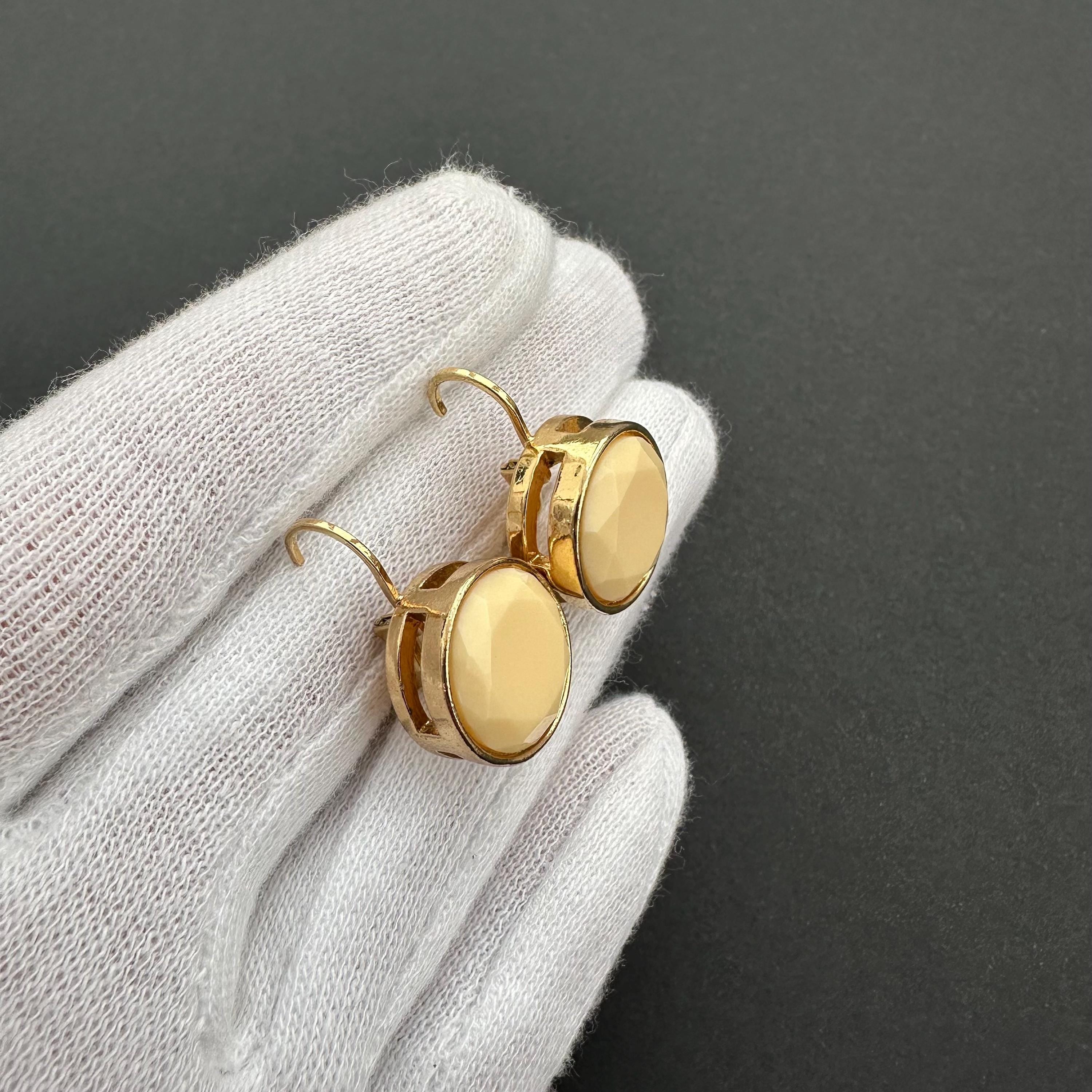 Vintage gold-tone and beige cabochons dangle openwork earrings