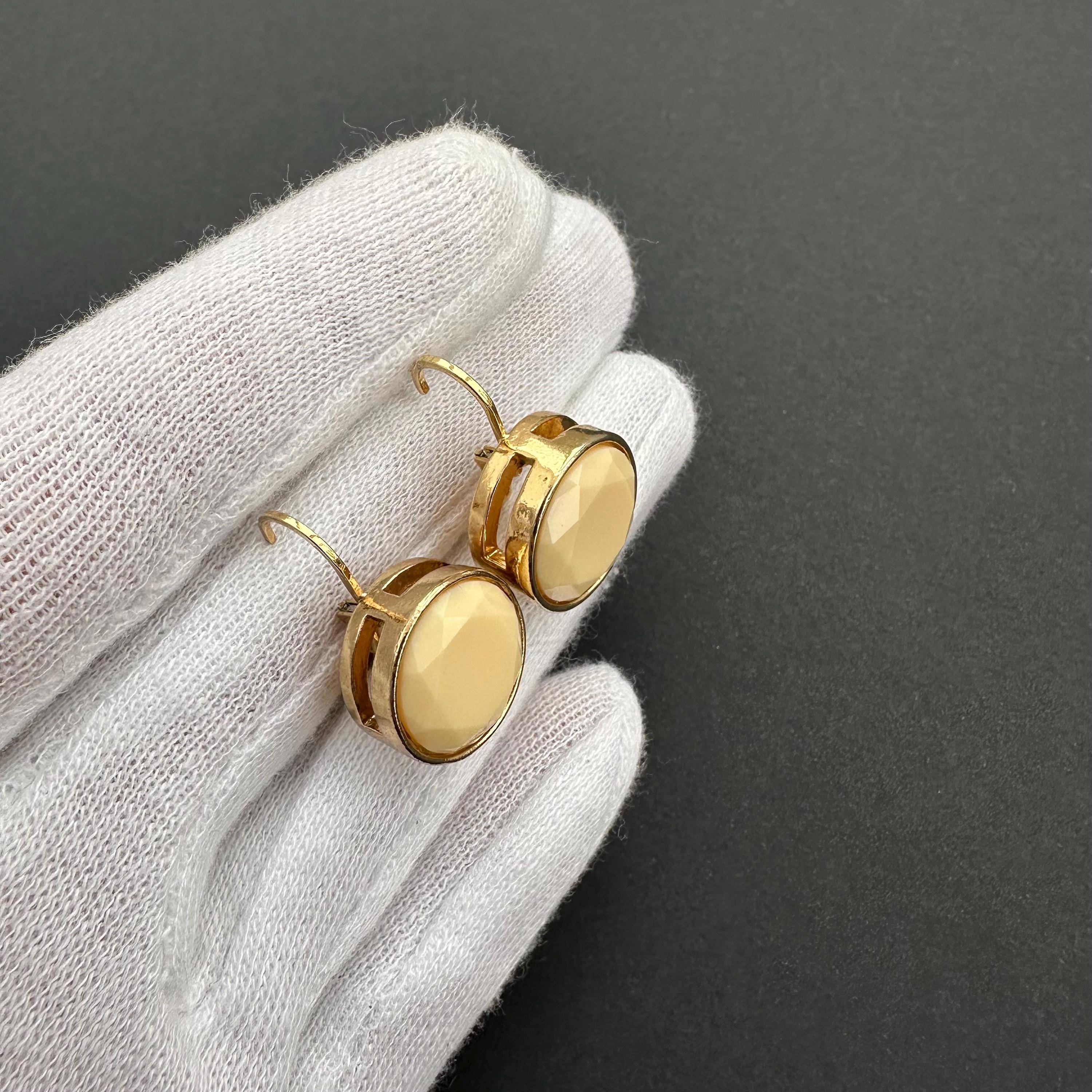 Vintage gold-tone and beige cabochons dangle openwork earrings