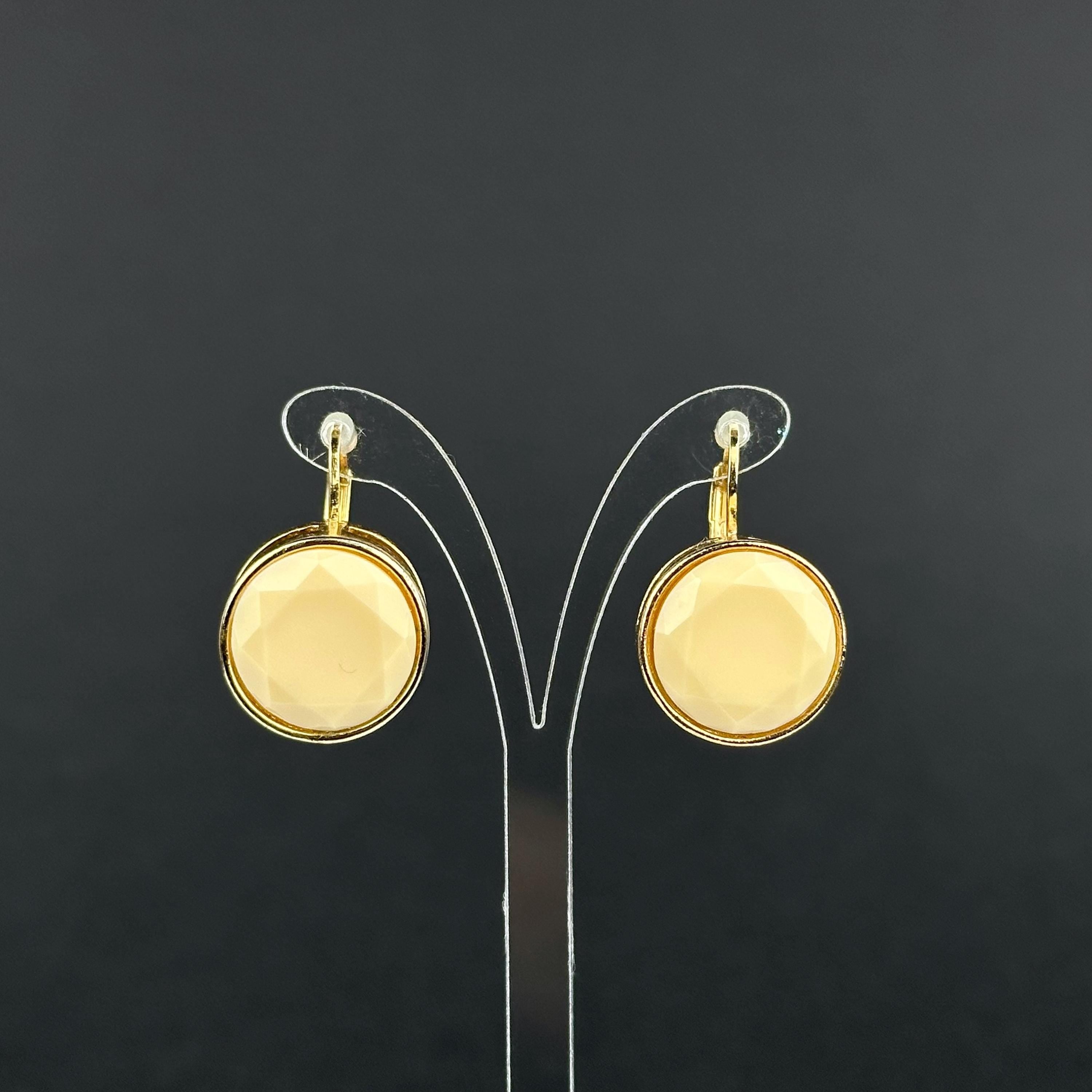 Vintage gold-tone and beige cabochons dangle openwork earrings