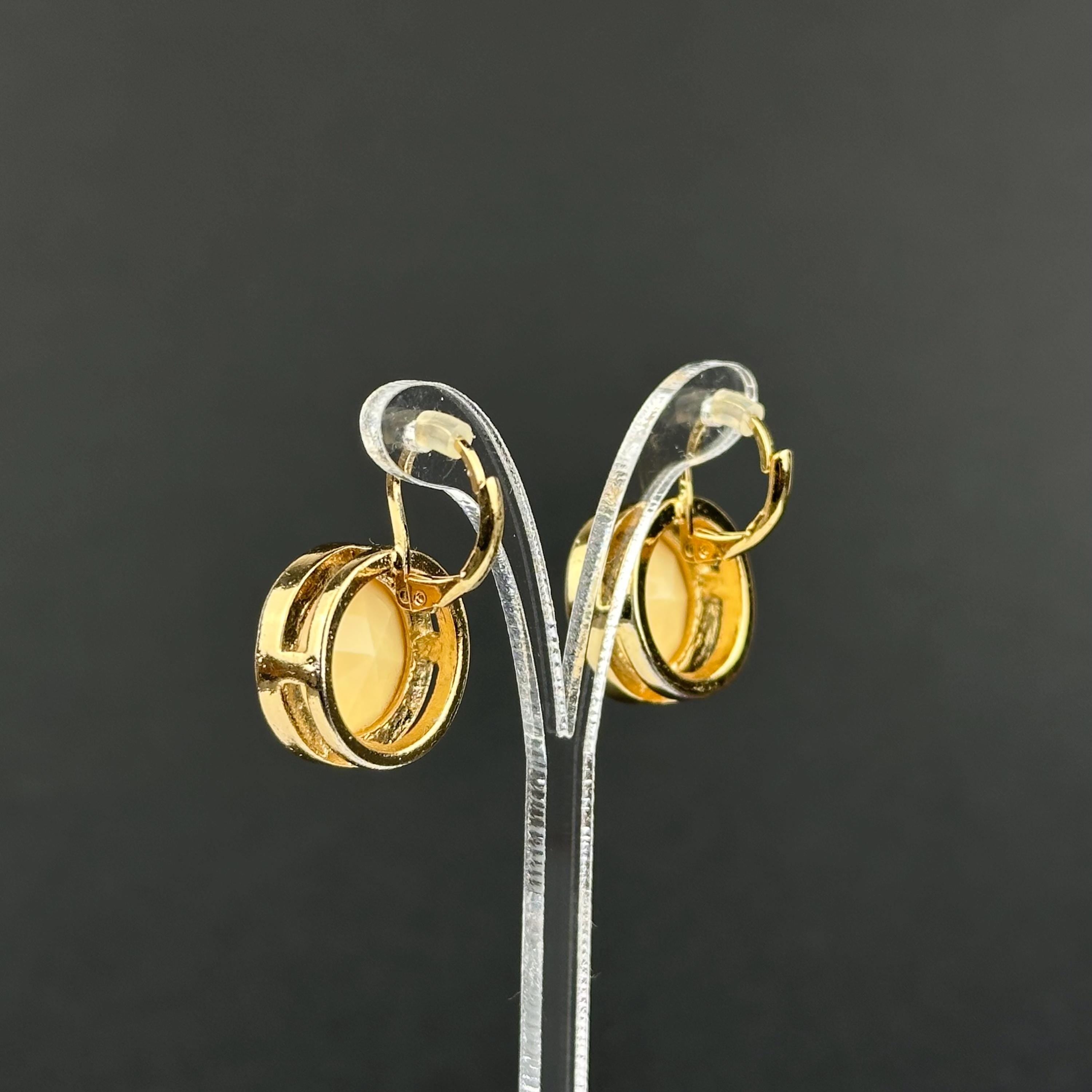 Vintage gold-tone and beige cabochons dangle openwork earrings