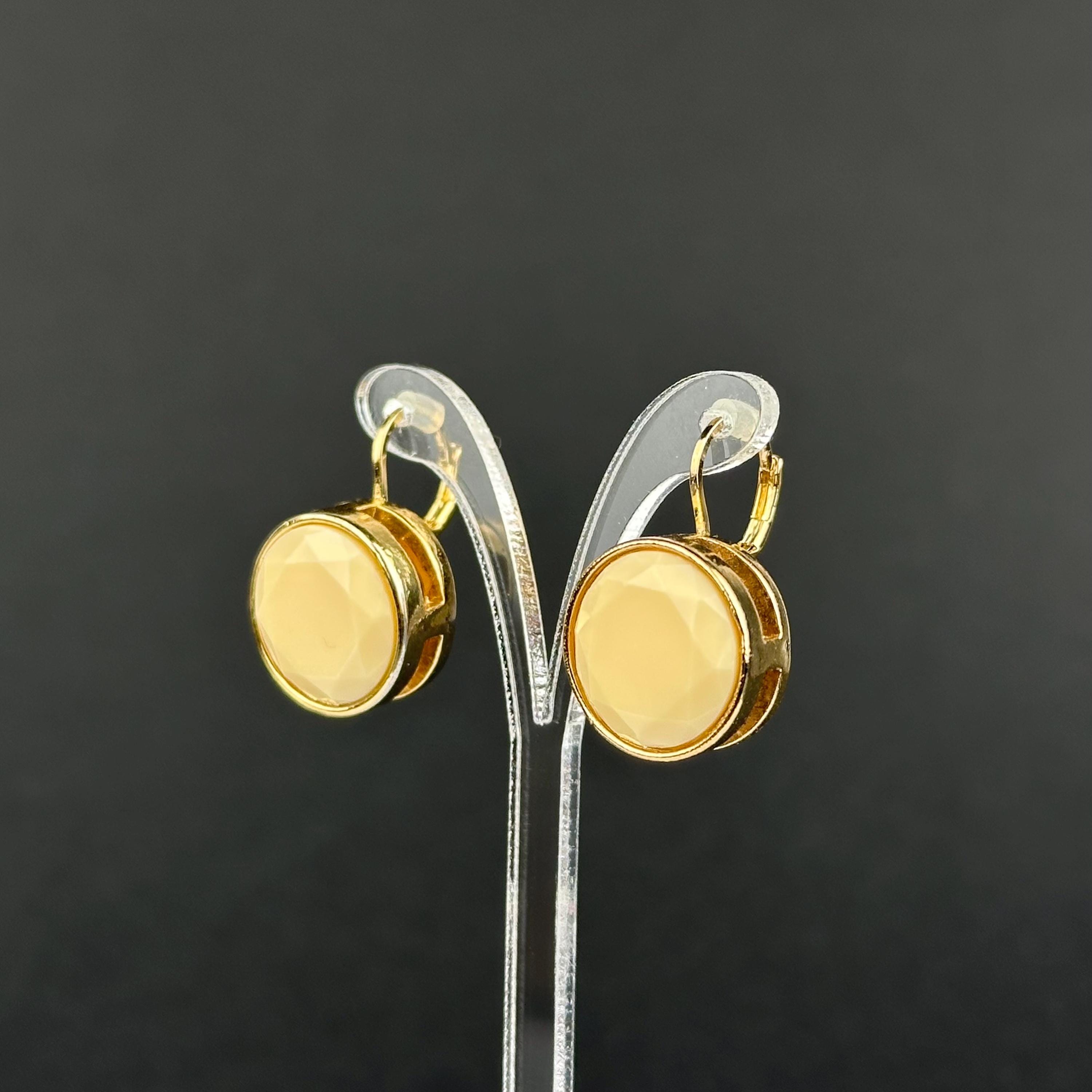 Vintage gold-tone and beige cabochons dangle openwork earrings