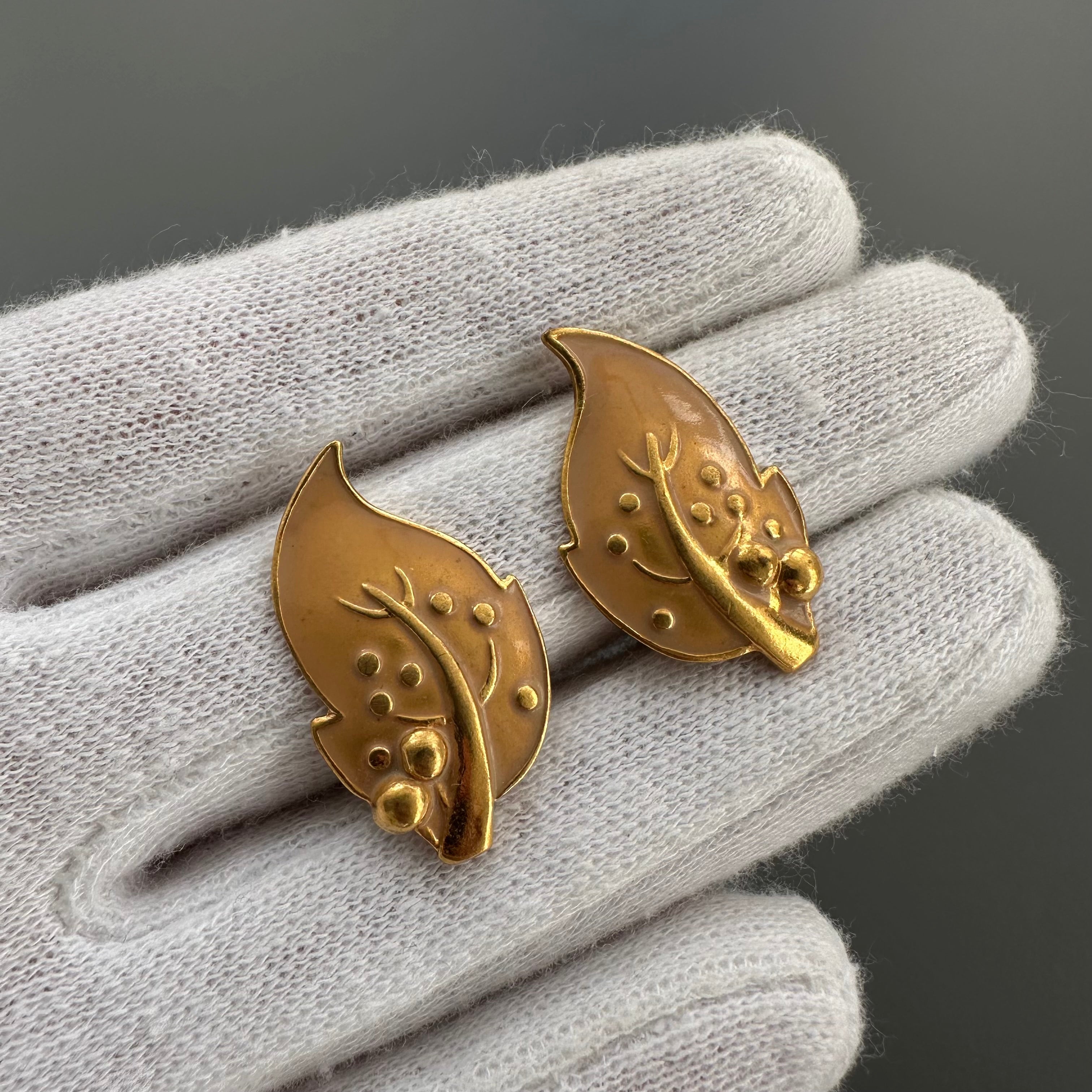 Vintage gold plated and beige enamel leaf clip on earrings.