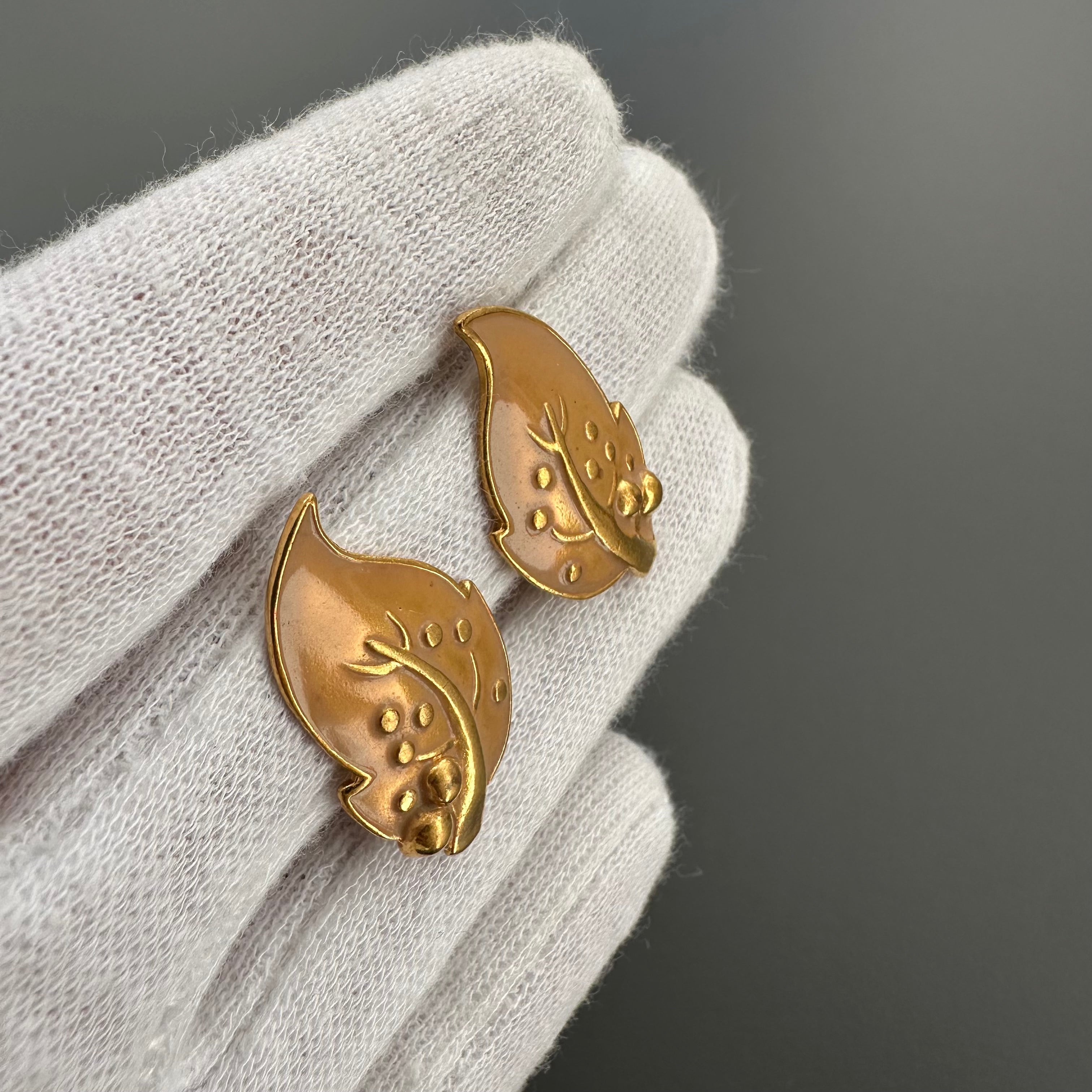 Vintage gold plated and beige enamel leaf clip on earrings.