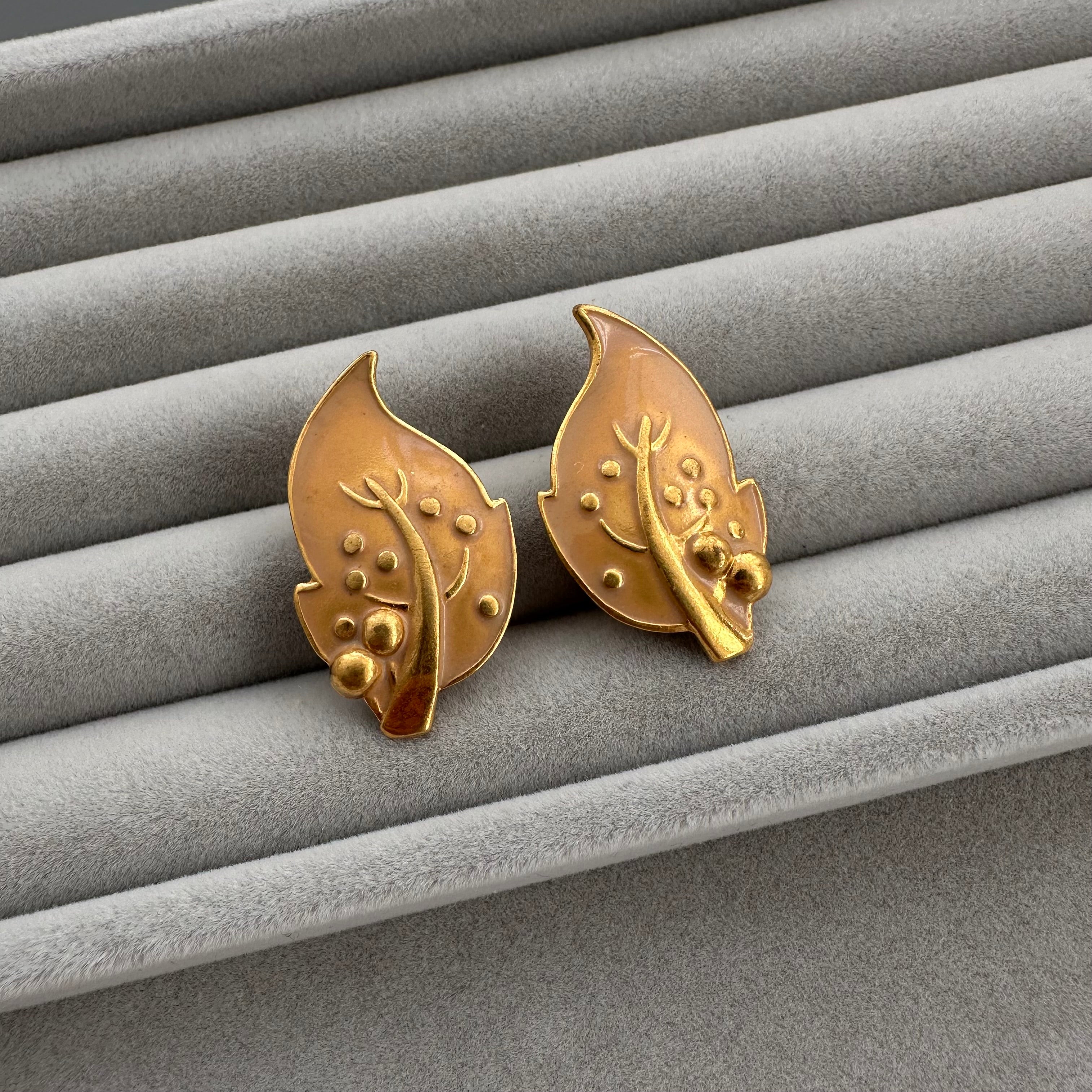 Vintage gold plated and beige enamel leaf clip on earrings.
