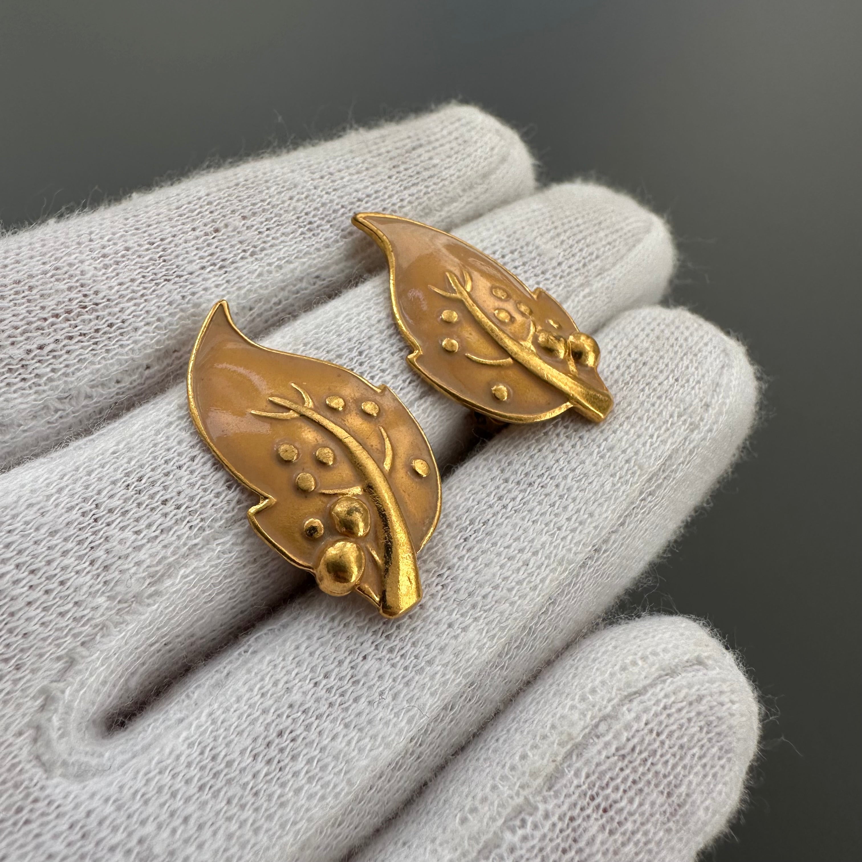 Vintage gold plated and beige enamel leaf clip on earrings.