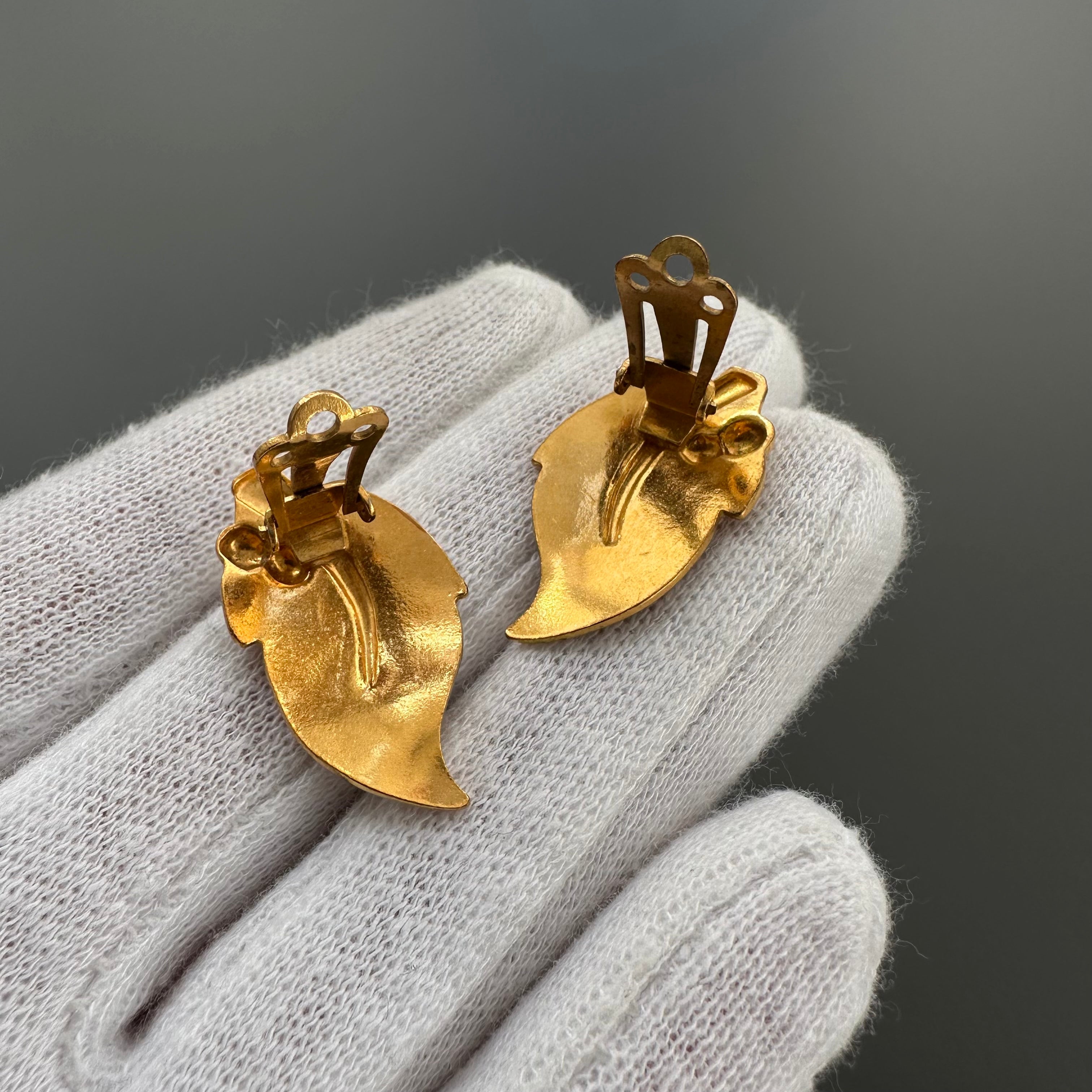 Vintage gold plated and beige enamel leaf clip on earrings.