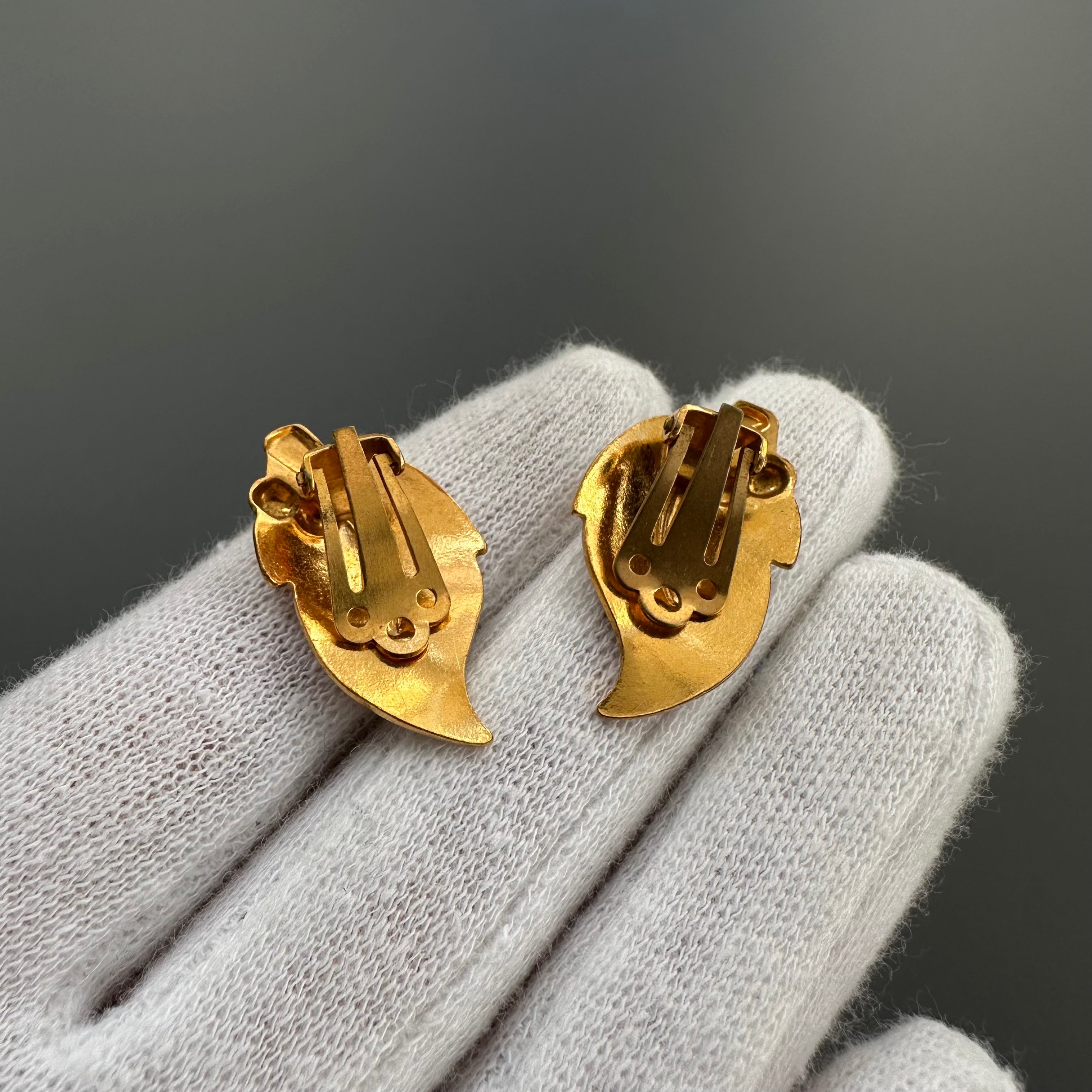 Vintage gold plated and beige enamel leaf clip on earrings.