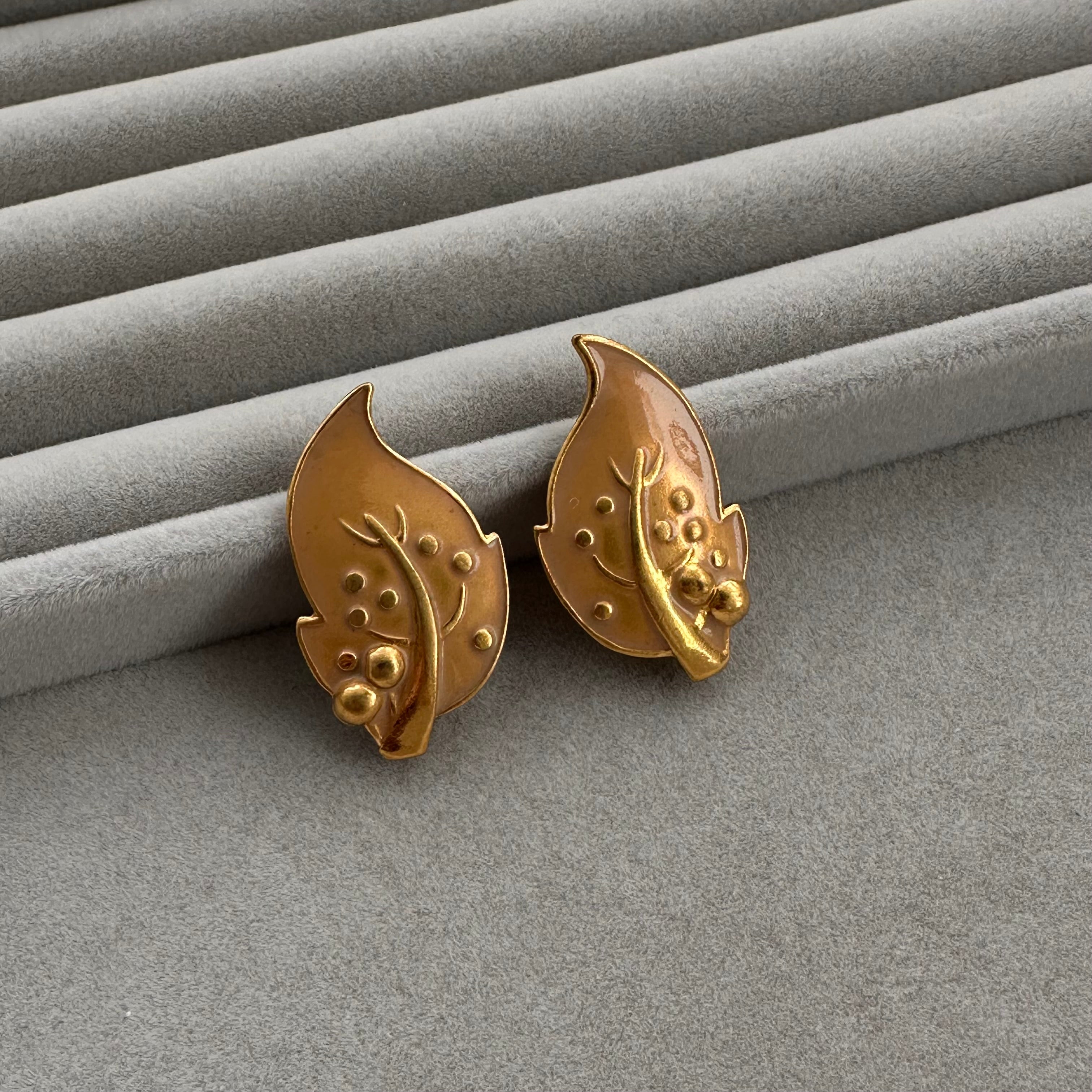 Vintage gold plated and beige enamel leaf clip on earrings.