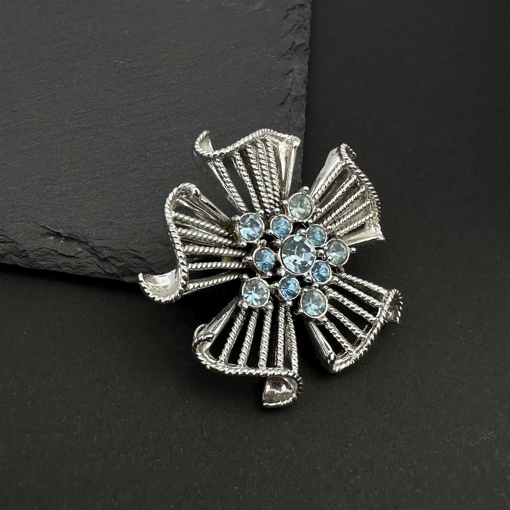 Vintage silver tone and blue rhinestone flower brooch