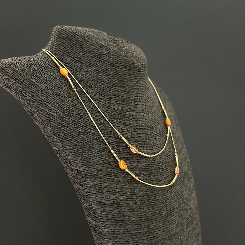 Vintage long gold-tone and amber plastic beads necklace