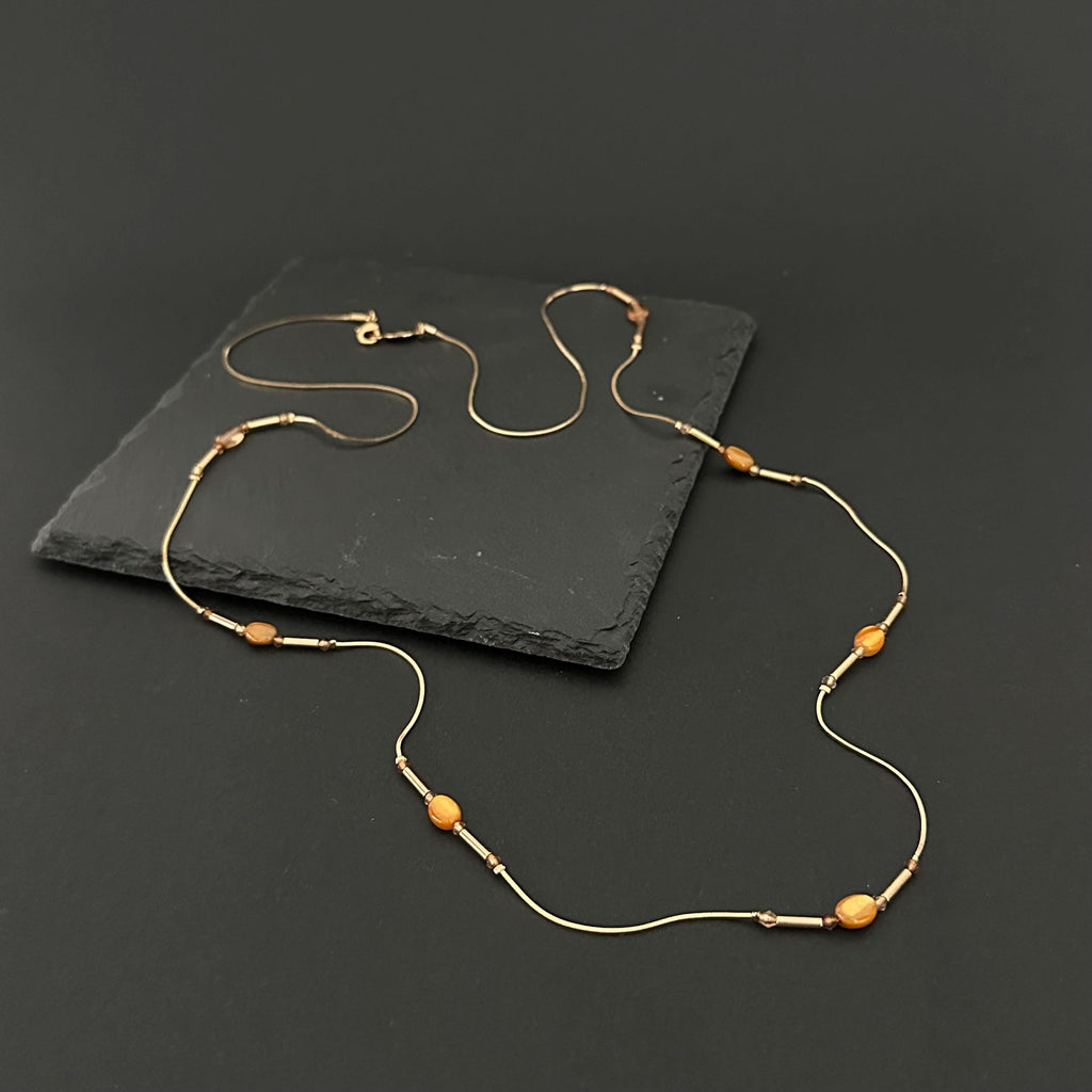 Vintage long gold-tone and amber plastic beads necklace