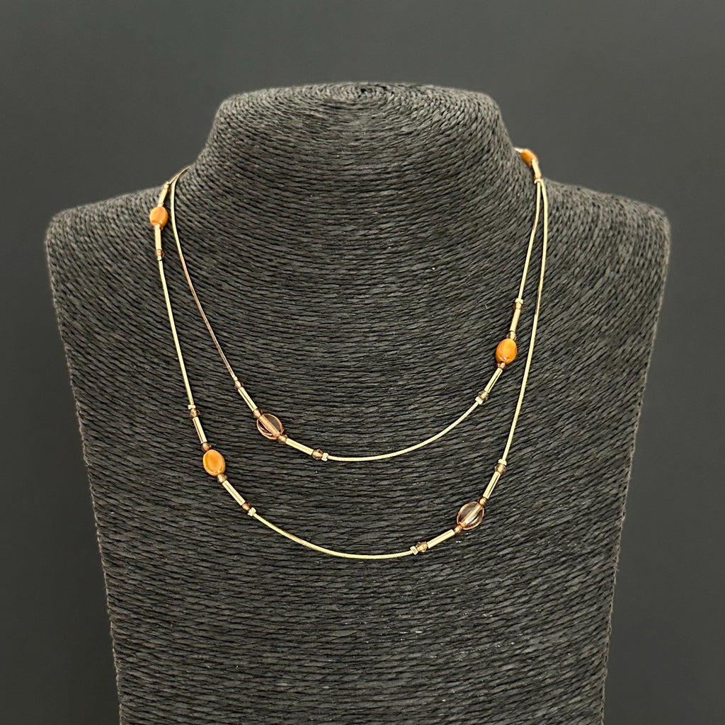 Vintage long gold-tone and amber plastic beads necklace