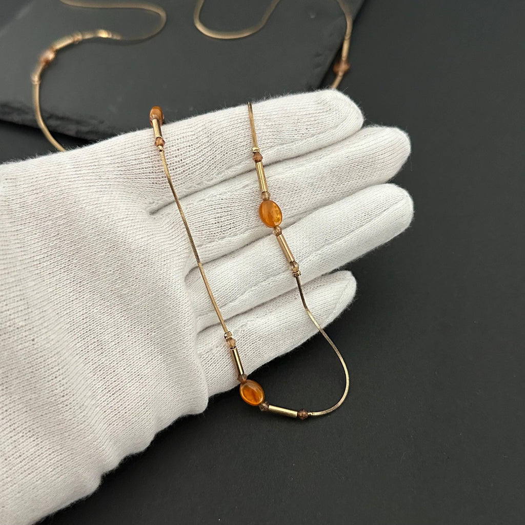 Vintage long gold-tone and amber plastic beads necklace