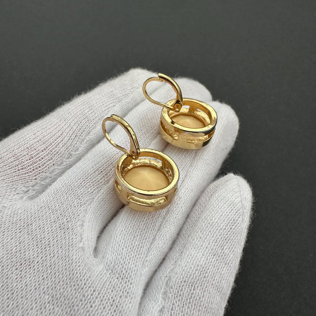 Vintage gold-tone and beige cabochons dangle openwork earrings